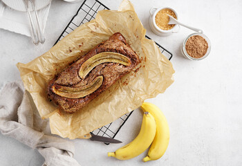 Homemade banana bread topping close-up on board on table. Horizontal top view from above, copy spase