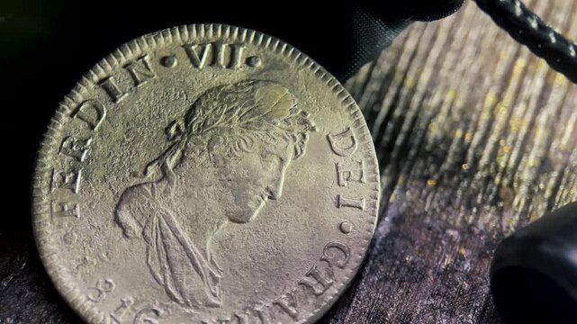 Coin close up the detailed macro of an old 2 reales spain silver coin reveals its intricate weathered history.