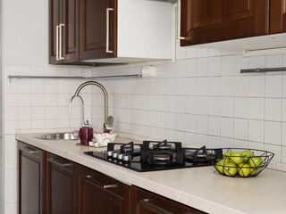 Home chef organizing tools in compact kitchen environment