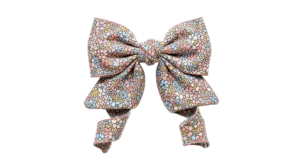 A decorative floral print fabric bow with trailing ribbons isolated on transparent background