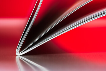 Minimalist close-up of an open notebook forming geometric lines on a uniform background