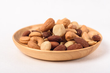 Mixed nuts consisting of almonds, cashews and peanuts, roasted with salt. Healthy snack on white background.