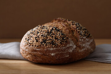 Healthy vegan dark rye sourdough bread topped with sesame and flaxseed