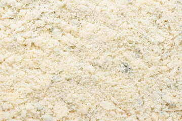 Grated parmesan cheese texture background. Ingredient in Italian cooking such as pasta
