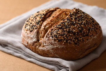 Healthy vegan dark rye sourdough bread topped with sesame and flaxseed