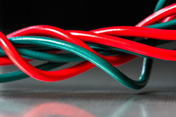 Twisted and tangled electrical wiring cord in an industrial space, close-up view