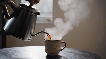 Hand pouring hot steaming coffee from a gooseneck kettle into a textured ceramic mug creating a - Powered by Adobe