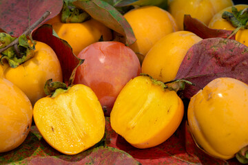 Bright orange persimmons and autumn leaves