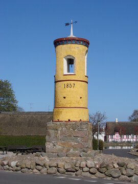 The historic Nordby Water Tower from 1857 on Sams&oslash; Island, Denmark. This bright yellow landmark stands under a clear blue sky, symbolizing Danish rural heritage and early innovation.