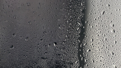 background, drops of morning dew, condensation on the glass. wet glass. water drops close-up. beautiful background for text. Spray cool condensate water on the glas. unusual, abstract. macro photo