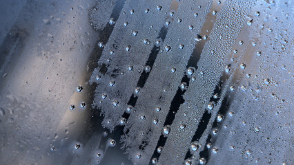background, drops of morning dew, condensation on the glass. wet glass. water drops close-up. beautiful background for text. Spray cool condensate water on the glas. unusual, abstract. macro photo