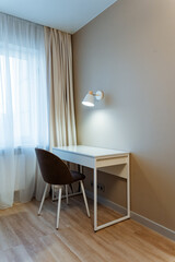 calm study nook near window, serene work space with natural illumination and simple furniture design, peaceful study environment featuring minimalist setup and calming natural light ambiance
