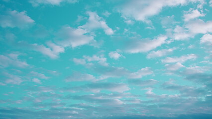 A Serene and Calm Sky with Soft, Fluffy Clouds Floating Over a Beautiful Turquoise Backdrop