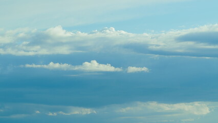 A Serene Blue Sky Filled with Soft, Fluffy Clouds Creating a Dreamy Atmosphere Above