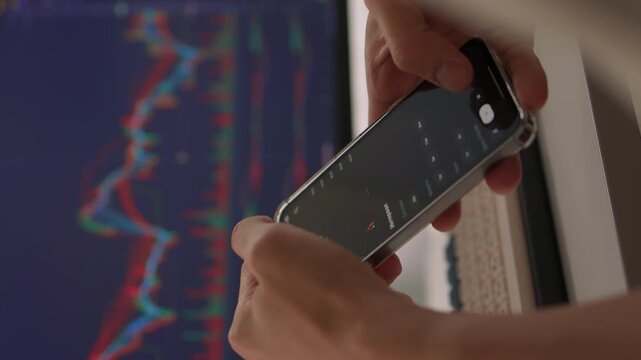 Trader observes price fluctuations closely, Hands manipulate trading charts intensely during session, Trader focuses on chart patterns and volume data to make informed choices