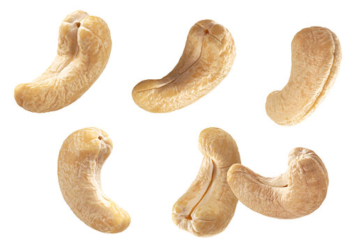 a photograph capturing five raw or roasted cashew nuts floating dynamically in the air, emphasizing their characteristic curved shape, isolated on a pure transparent background.