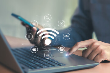 Business using laptop with wifi icon global business communication social network concept	