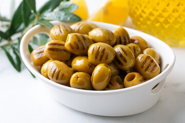 Grilled green olives. Tasty organic green olives in the plate.