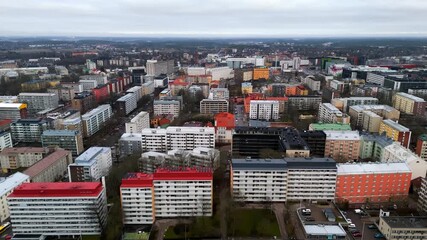 Aerial tracking shot over colorful condos in Turku city, rainy day in Finland