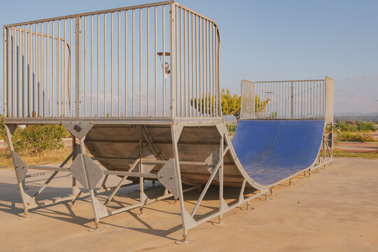 Empty concrete skate park ramp for skateboarding and rollerblading action sports