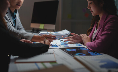 Business people analysing data, planning strategy in office
