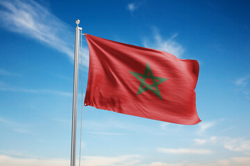 Morocco flag waving in the wind on blue sky background.