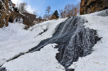 frozen Jermuk waterfall and red rocks of Arpa river canyon (Vayots Dzor, Armenia)