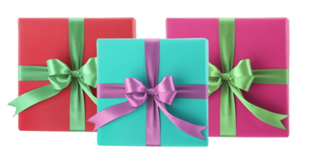 three brightly colored, contemporary square gift boxes wrapped in vibrant paper and tied with contrasting satin ribbons and neat bows isolated on black.