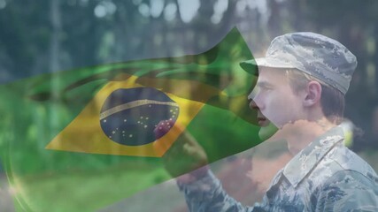Soldier responding to call, raising and lowering military salute while Brazil flag overlay rippling - Powered by Adobe