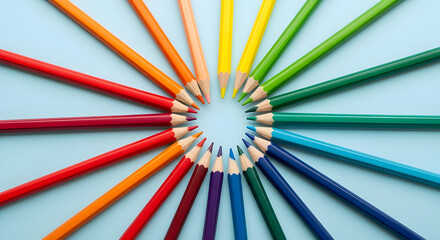 Colorful group of wooden color pencils arranged on a blue background suitable for art and school use