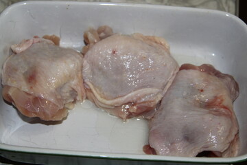 piece of raw chicken in a baking dish, large, 