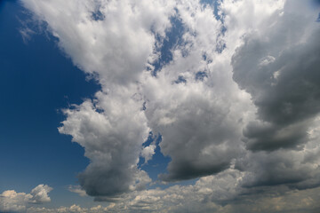 A stunning and dramatic cloudscape showcasing a vibrant blue sky filled with fluffy clouds