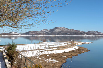 Snowy Lake Plastira at Dawn with Calm Waters