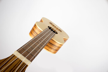 The guitar is made of beautiful wood. The ukulele. isolated. view from above