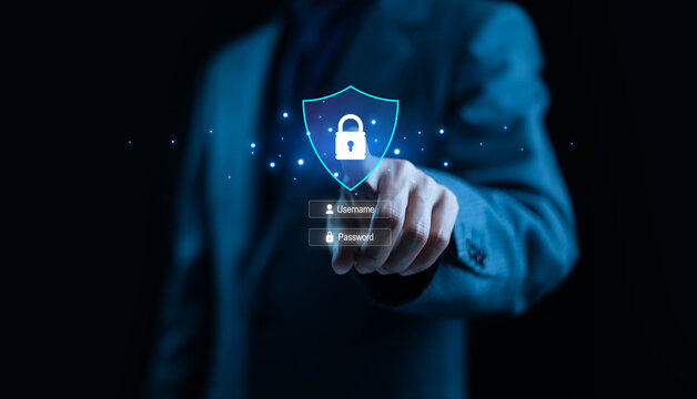 Business person touching a digital shield with lock icon and login fields, representing cybersecurity protection, secure authentication, data privacy, password security, and safe access in modern.