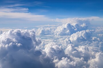 High-altitude photograph of white clouds drifting over a blue sky, serene sky panorama with ample open space
