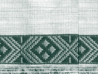 piece of green ethnic cloth with rough texture