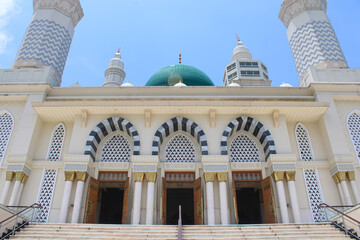 Entrance Facade of Majestic Mosque with Archways and Minarets