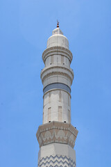 Elegant Modern Mosque Minaret Against Clear Blue Sky