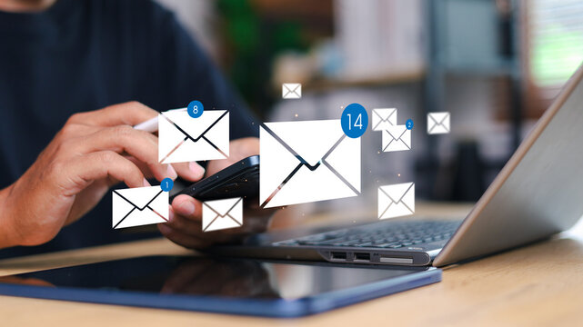 Person checking smartphone with email icons floating above. Concept of digital communication, mobile inbox, real-time notification, and online message system.