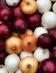 Background with different types of onions - white, red, yellow onions close-up view. Natural vegetable texture.