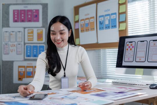 Woman designer creating mobile application user interface layout