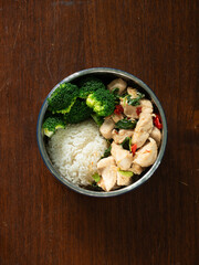 Thai healthy lunch box - PAD KAPRAO, Thai stir fried holy basil with chicken breast, chili and garlic, served with rice and boiled broccoli