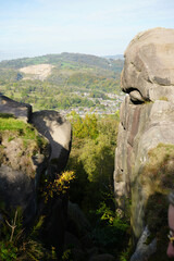 Expansive Scenic View From Ancient Black Rocks Overlooking Cromford Village, A Distant Quarry, And Vibrant Autumn Trees In Derbyshire, England.