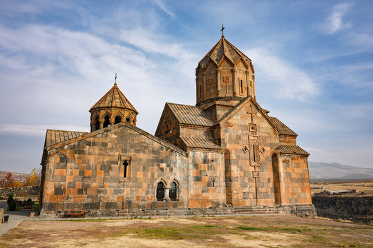 An Armenian Hovhannavank monastery church with a cross on top and a small cross on the side