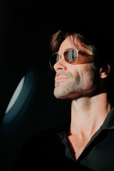 Confident man wearing sunglasses looking away in sunlight