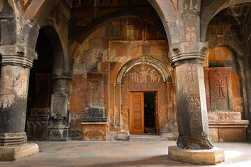 The inside of a Armenian Hovhannavank monastery church with arched doorways and pillars