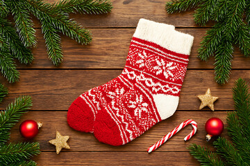 Festive Christmas stocking with candy cane and ornaments, perfect for holiday greetings or cozy winter promotions, evoking warmth and nostalgic cheer