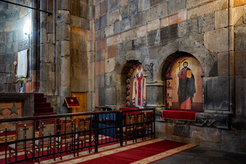 A Armenian Hovhannavank monastery church with a red carpet and a red cross on the floor