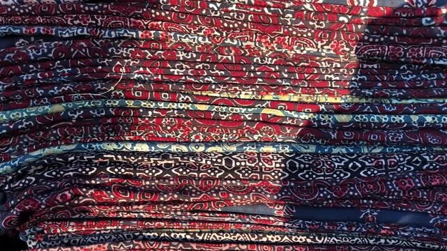 Close-up video of traditional Sindhi Ajrak printed fabric showcasing detailed block-print patterns, rich colors, and cultural textile design.